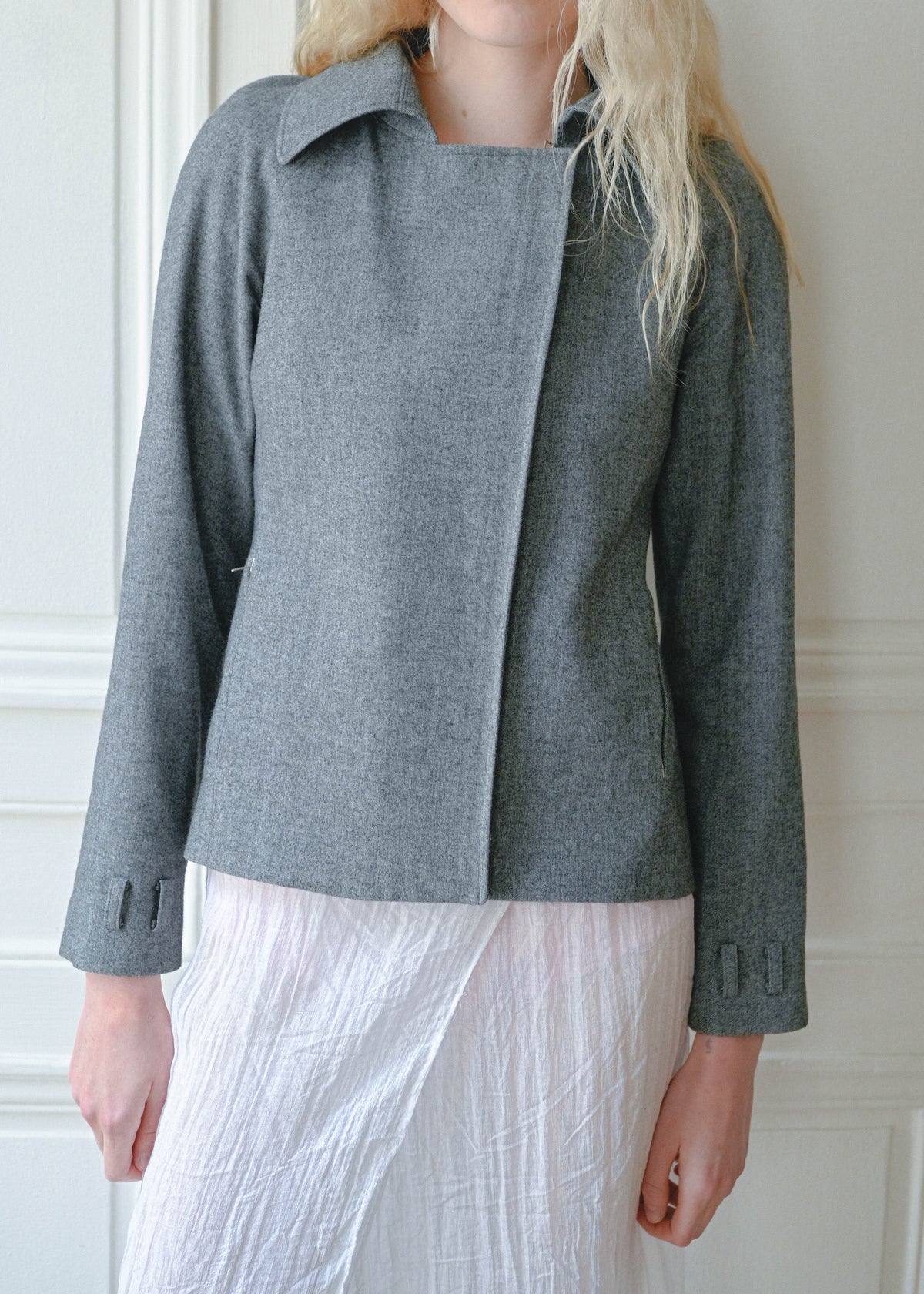 Vintage Kostas Murkudis grey tailored jacket worn with a white maxi skirt, close up, TURN Paris