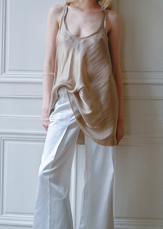 TURN Paris Hue Tunique in golden beige satin worn with white satin trousers, front view