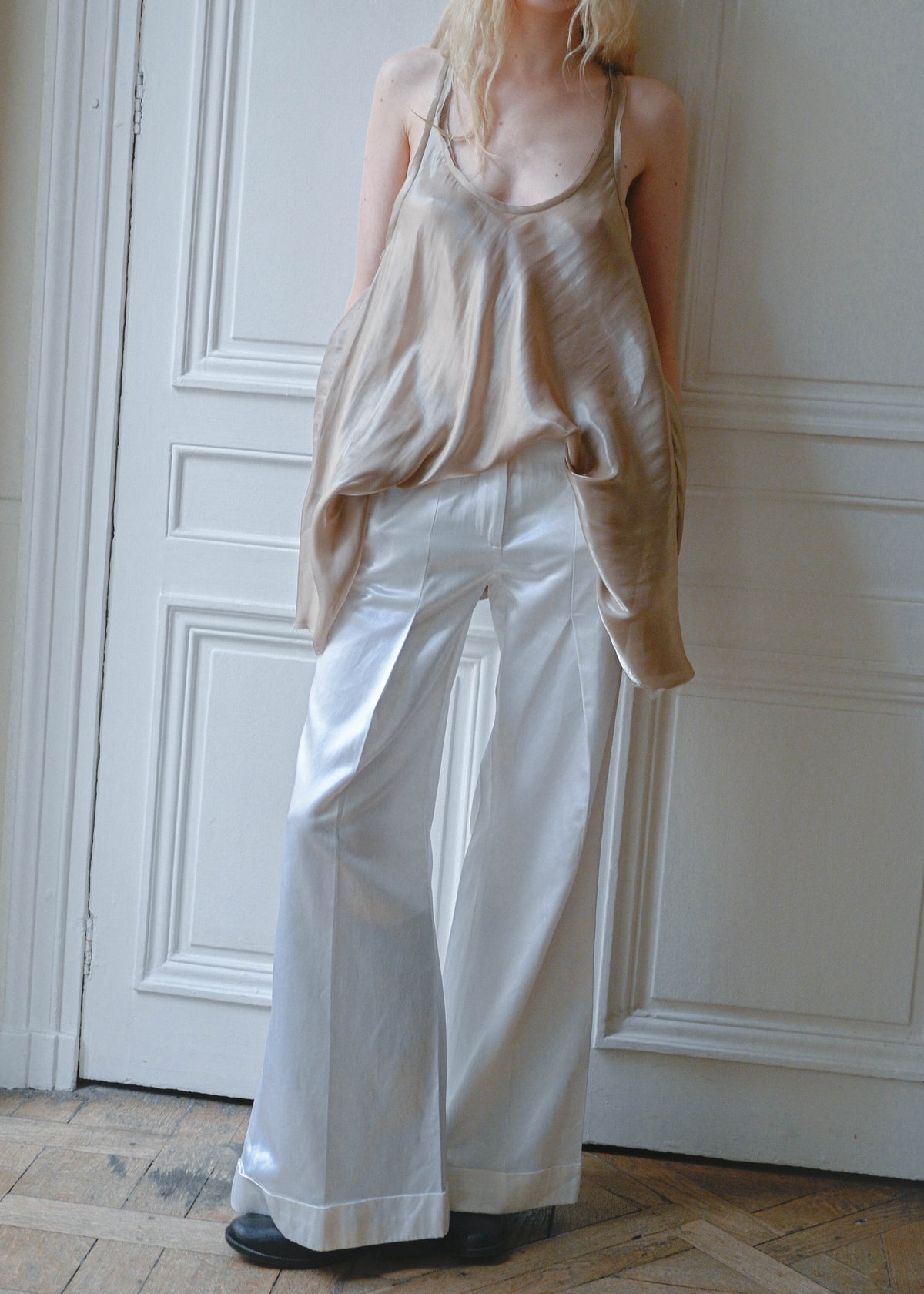 Vintage white satin straight leg trousers, worn with a beige satin camisole, close up, TURN Paris
