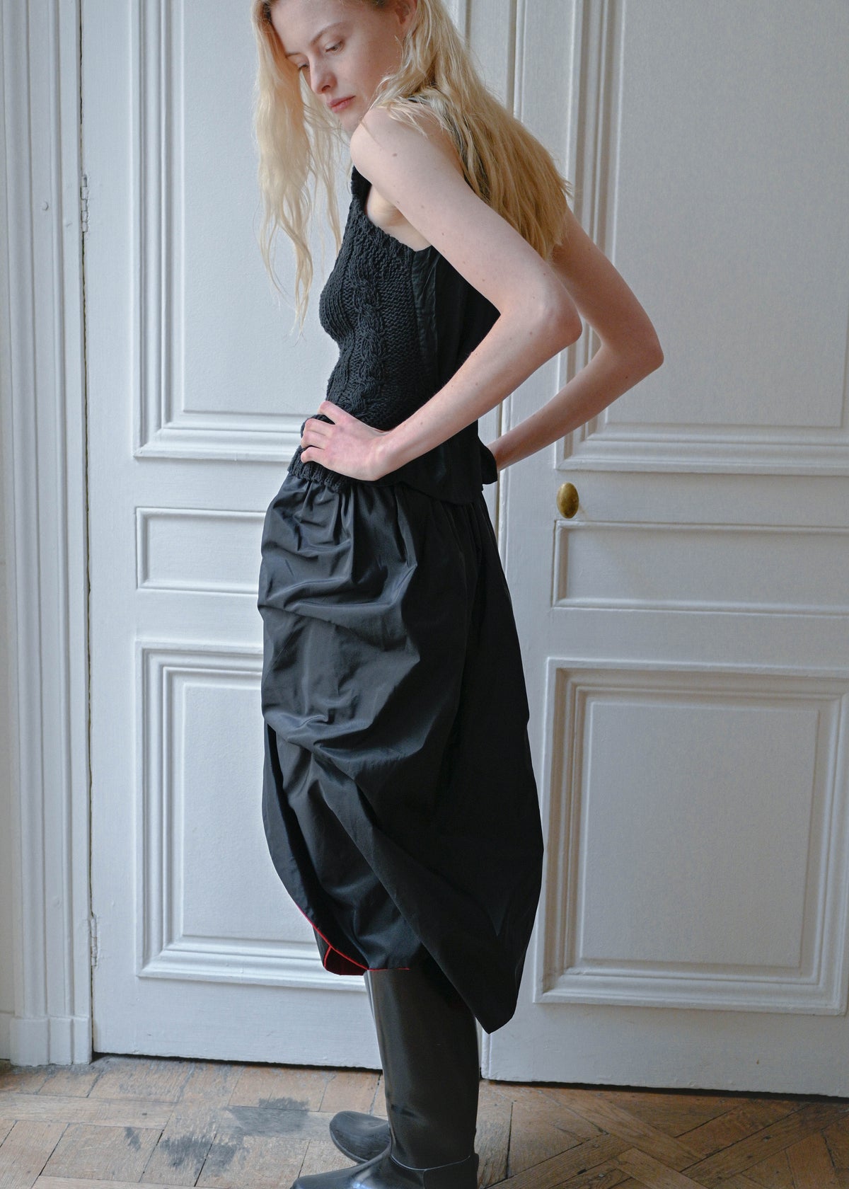 Vintage long black skirt with an open front and a red lining, back view, TURN Paris