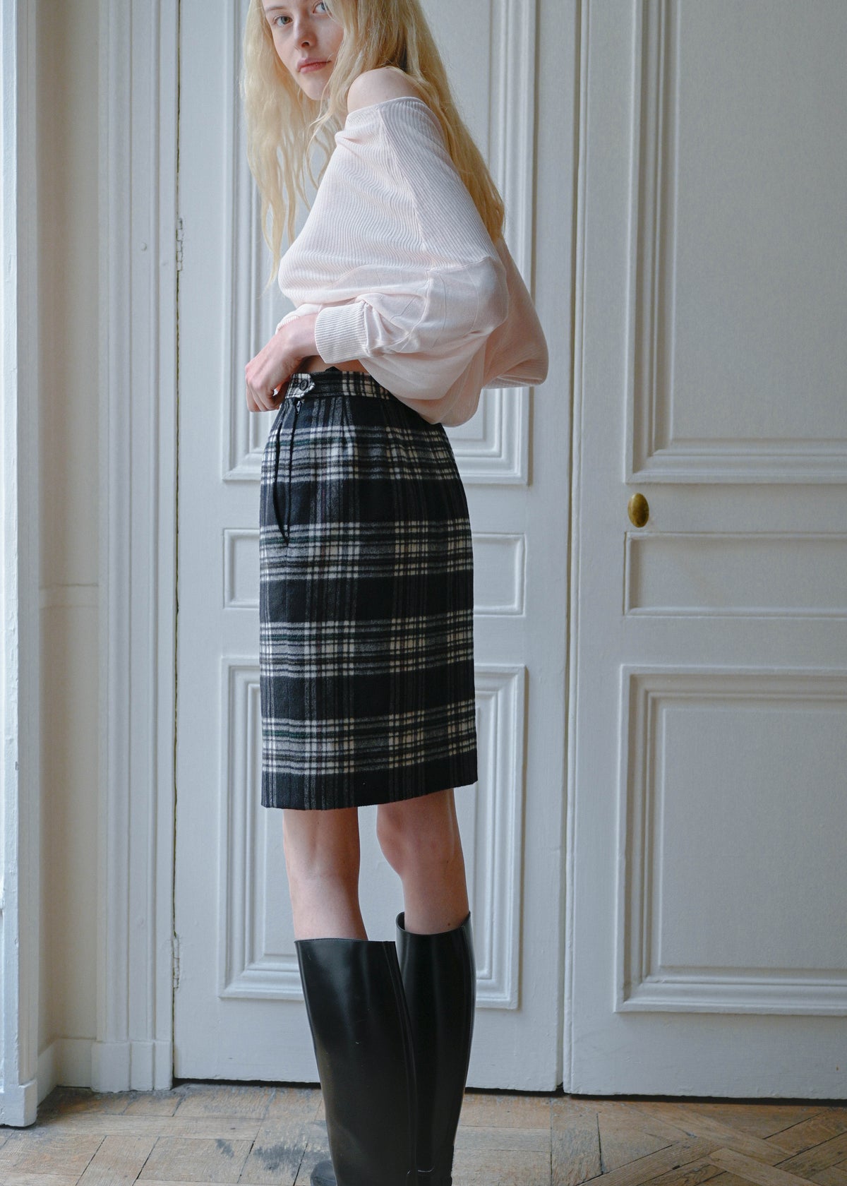 Vintage Yves Saint Laurent black and white check pencil skirt, worn with a sheer pale top, back view, TURN Paris