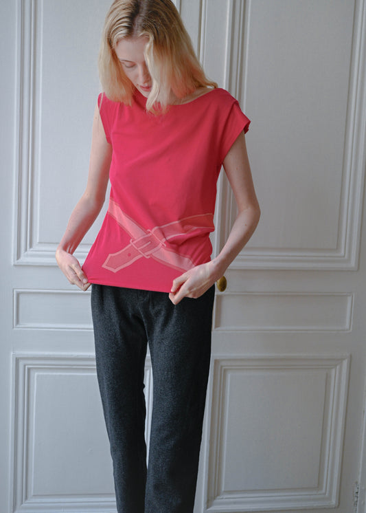 Vintage red sleeveless top with a trompe l'oeil belt print, worn with grey wool trousers, close up, TURN Paris