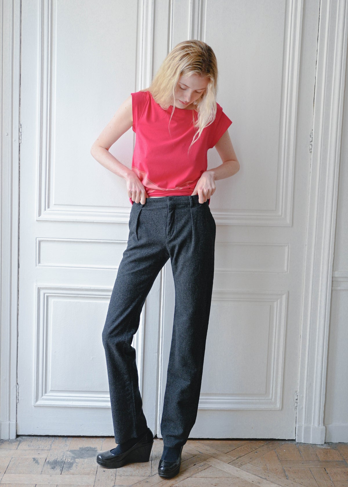 Vintage Celine grey wool trousers, worn with a red sleeveless top, front view, TURN Paris