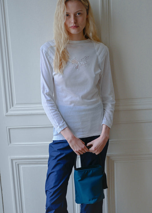 Vintage white long sleeve cotton top with a central embroidery, worn with the TURN Comeback Capri in blue, detail, TURN Paris