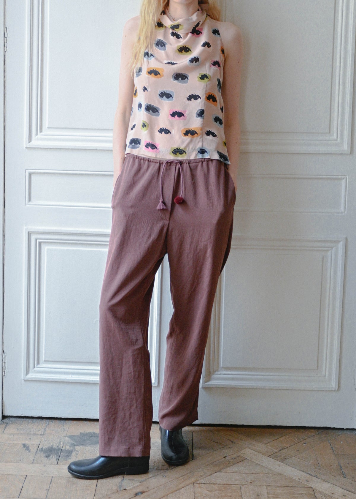 Vintage Moschino sleeveless top with an eyes print, worn with the TURN Loose Pant in burgundy, detail, TURN Paris