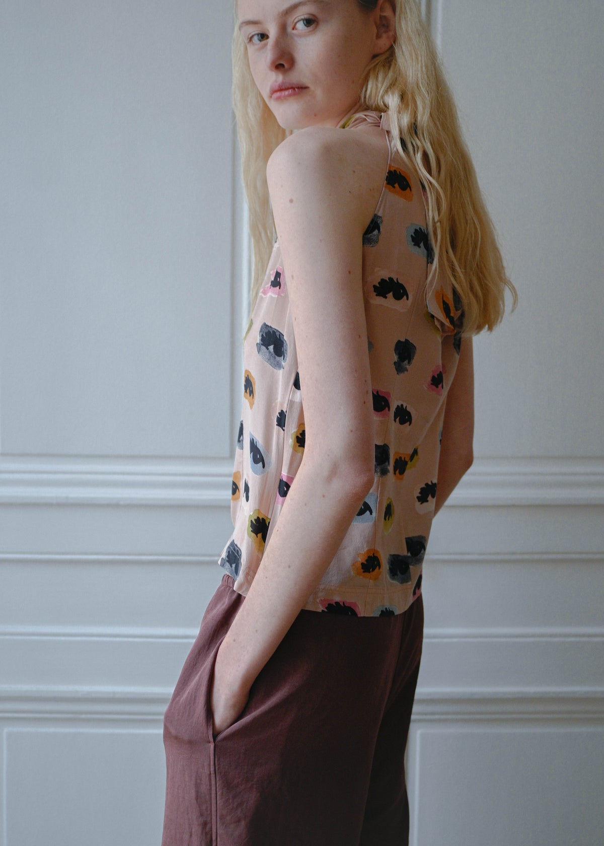 Vintage Moschino sleeveless top with an eyes print, worn with the TURN Loose Pant in burgundy, back view, TURN Paris