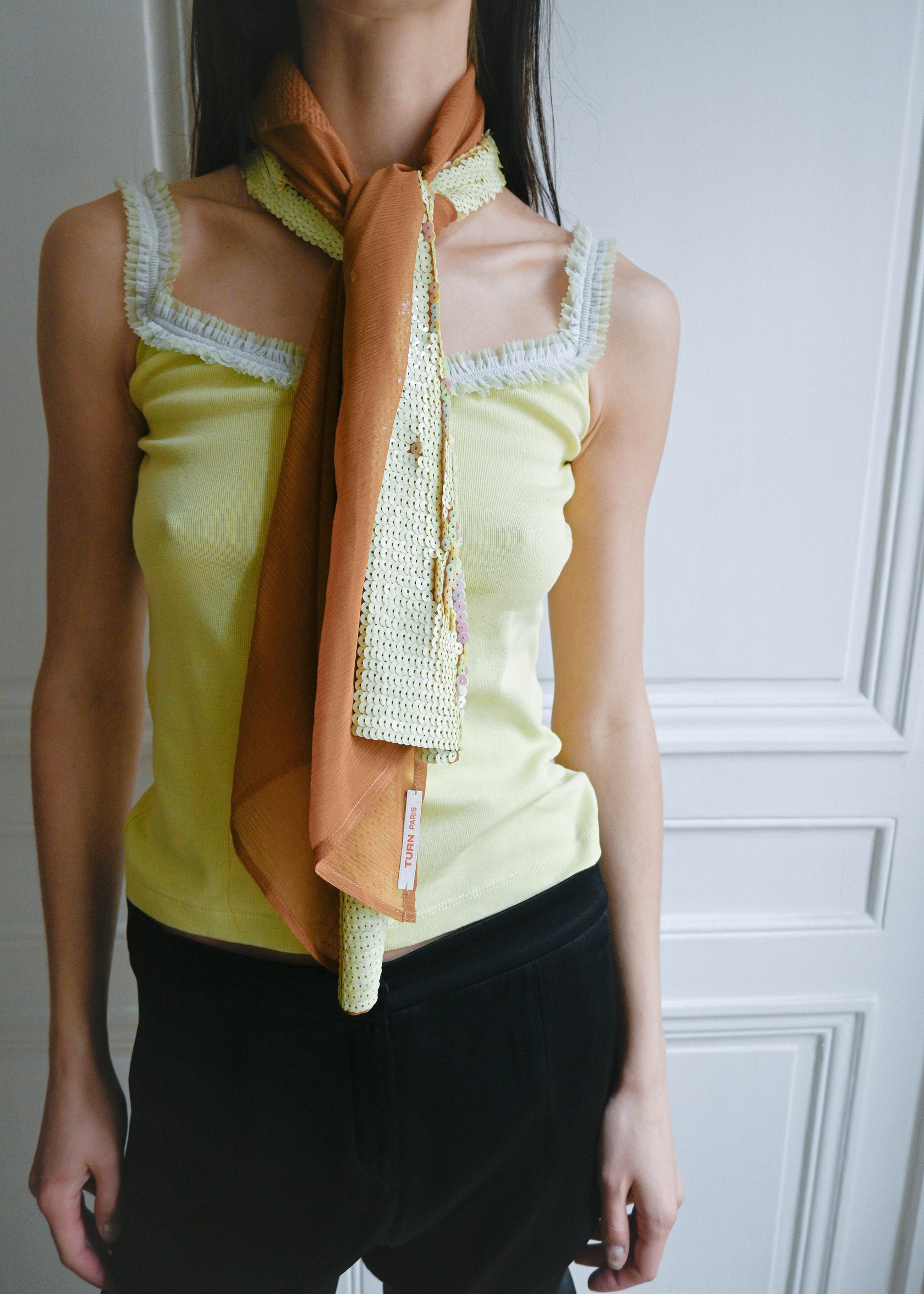 TURN PARIS SILK SCARF WOVEN FROM CAREFULLY SOURCED SILK CREPE.&nbsp;

ITS DRAPE FALLS SOFTLY WHILE THE EMBROIDERED 'T' IN CREAM AND SHINY PINK SEQUINS CATCHES THE LIGHT WITH MOVEMENT.

WEAR IT TIED AT THE NECK, KNOTTED AT THE WAIST, USE A TOP OR LOOSE OVER THE SHOULDERS.

130 CM LENGTH / 45 CM WIDTH - THIS PIECE IS ARTISAN MADE, SLIGHT VARIATIONS IN SIZE MAY OCCUR.