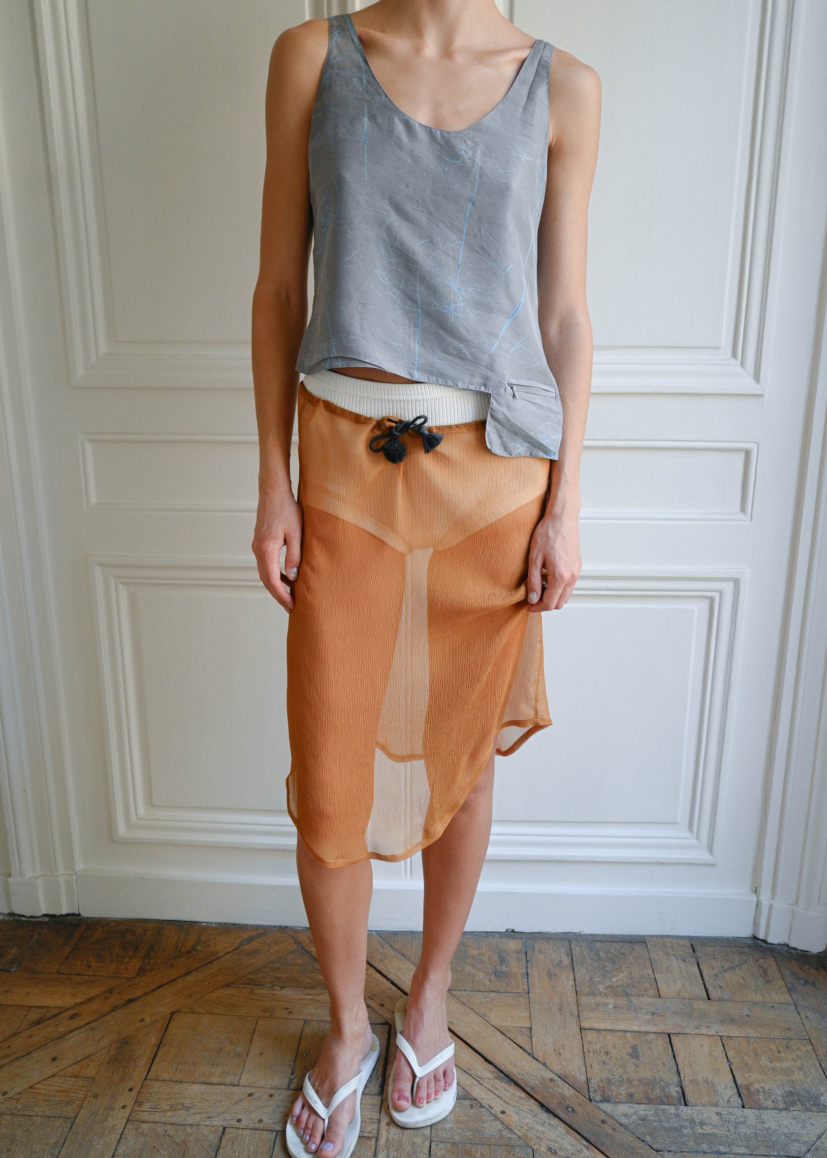 TURN PARIS midi skirt in bronze silk crepe.

Tied at the waist with a custom-made asymmetrical pompon made in France.

100% silk.
