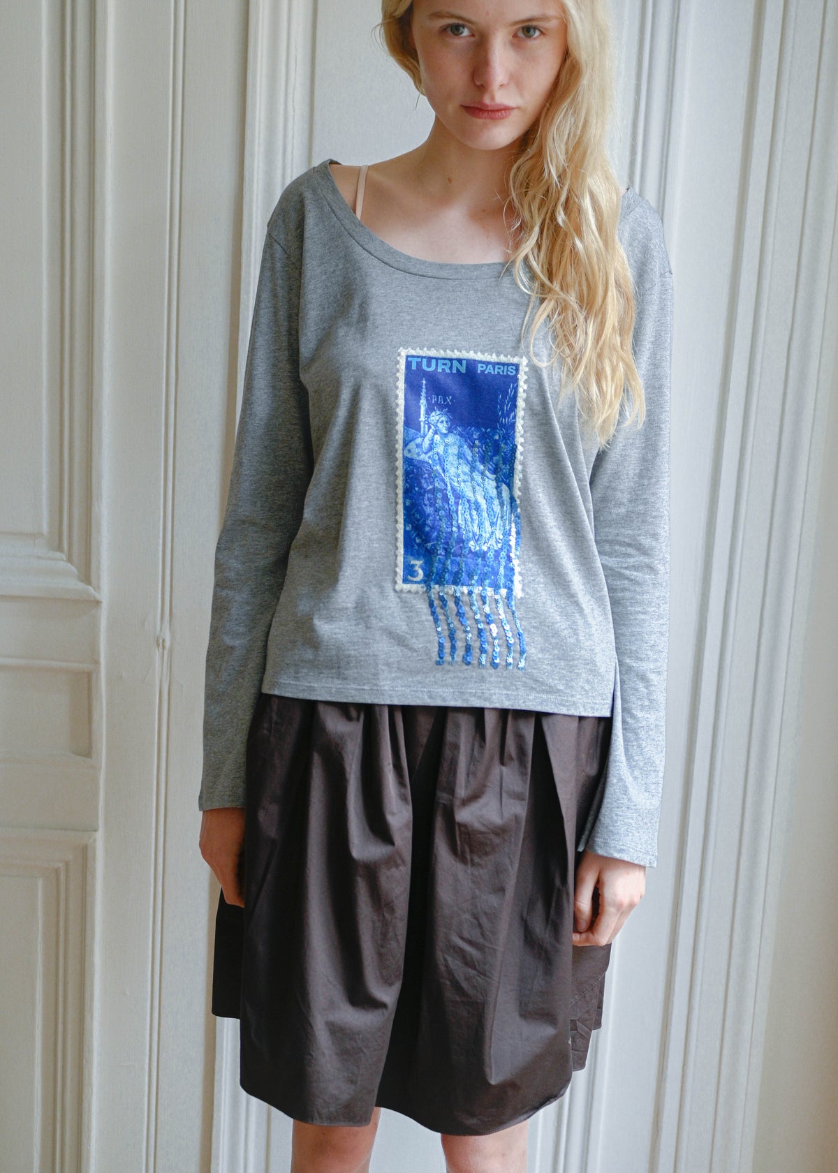 TURN Paris long sleeve tee in soft grey with a blue sequin embroidered stamp print. Made in Portugal.
