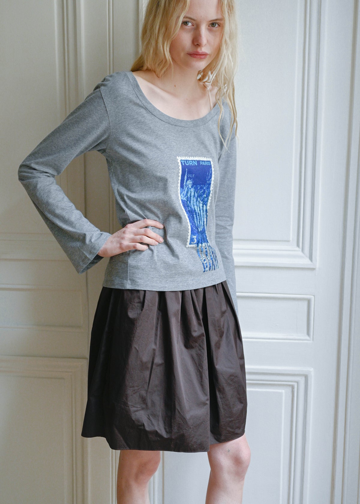 TURN Paris long sleeve tee in soft grey with a blue sequin embroidered stamp print. Made in Portugal.