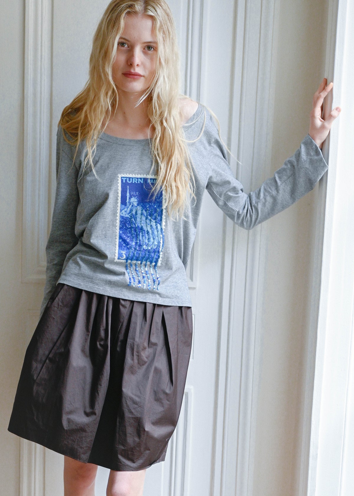 TURN Paris long sleeve tee in soft grey with a blue sequin embroidered stamp print. Made in Portugal.