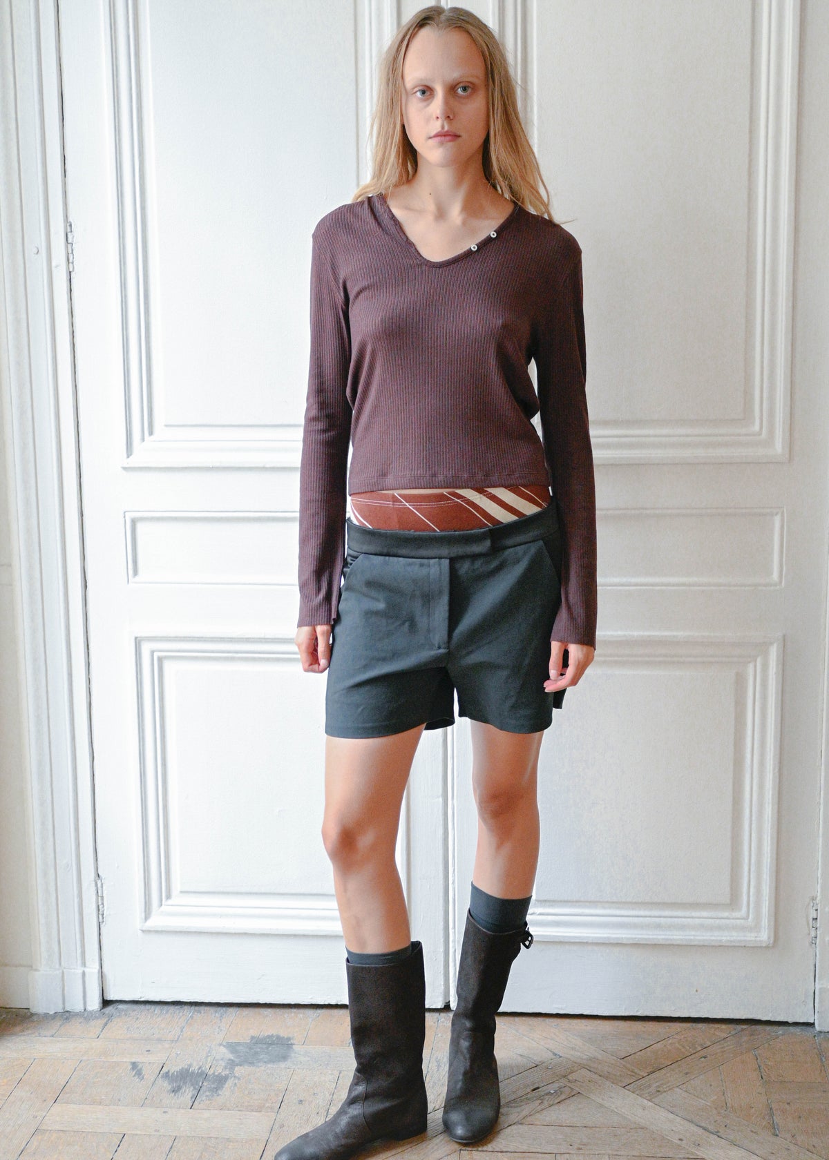 Black silk shorts worn with a plum knit top, front view
