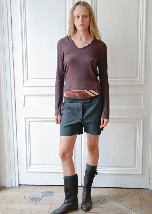 Black silk shorts worn with a plum knit top, front view