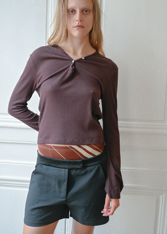 Black silk shorts worn with a plum knit top, front view