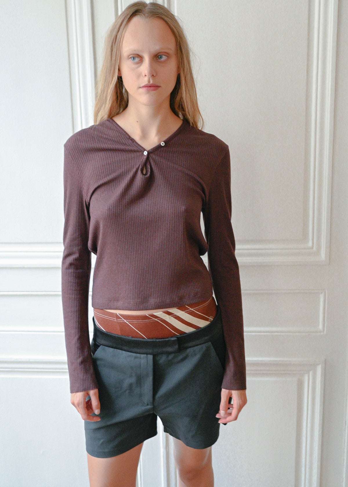 Black silk shorts worn with a plum knit top, front view