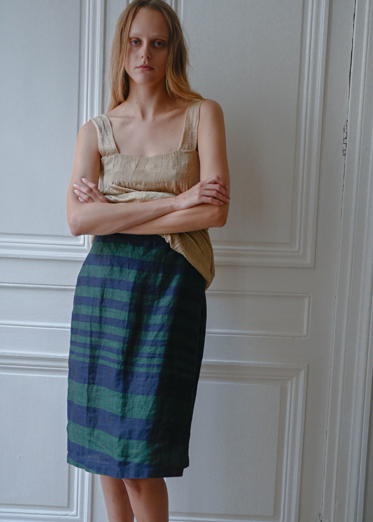 Striped linen skirt worn with gold textured mini dress, front view