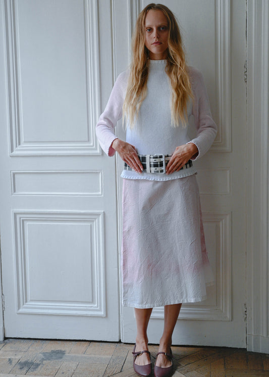 Pink and white knit sweater worn with crinkled print midi skirt and checks belt, front view
