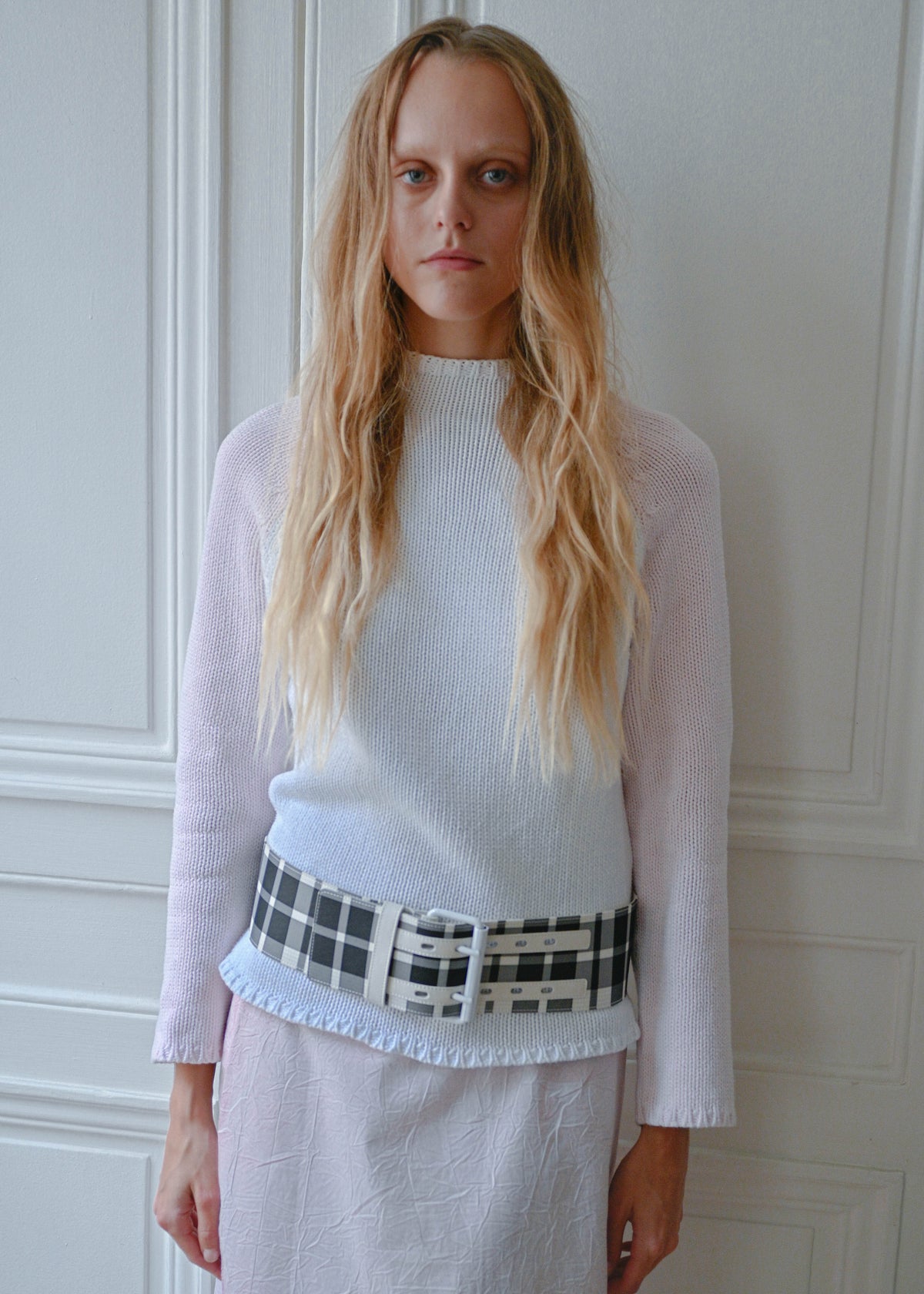 Pink and white knit sweater with checks belt, close-up