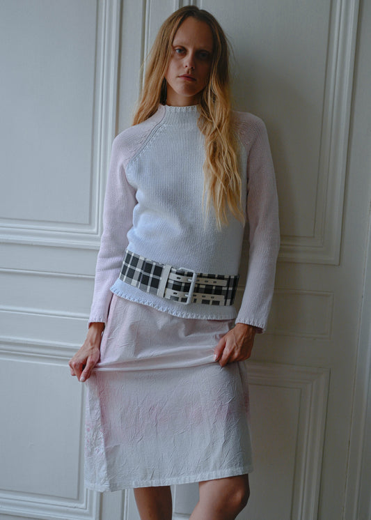 Crinkled print midi skirt worn with pink and white knit sweater, close-up