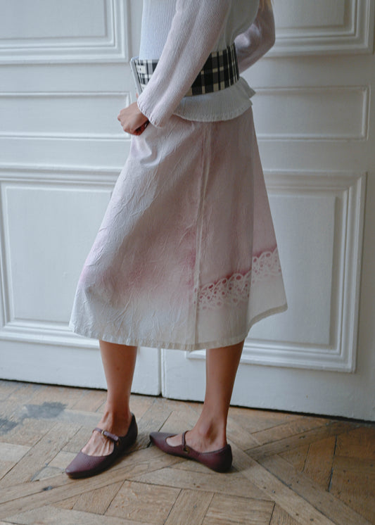 Crinkled print midi skirt worn with pink and white knit sweater, side view