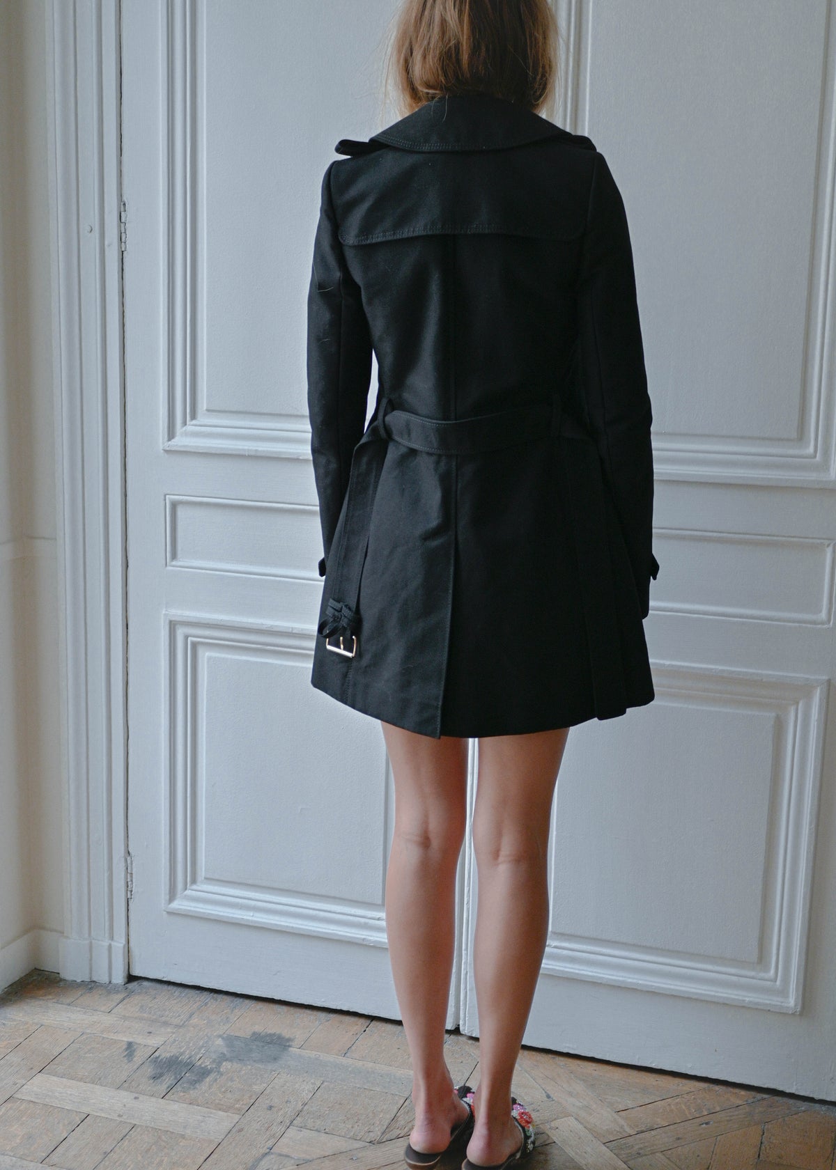 Black short trench coat, back view