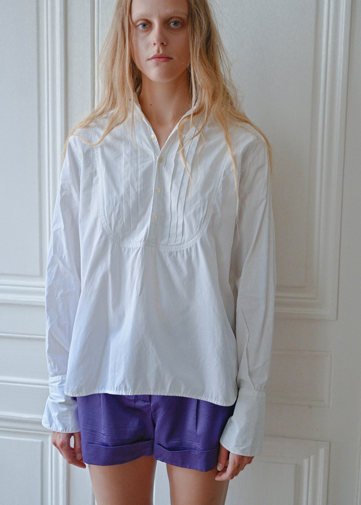 White cotton shirt worn with purple shorts, front view