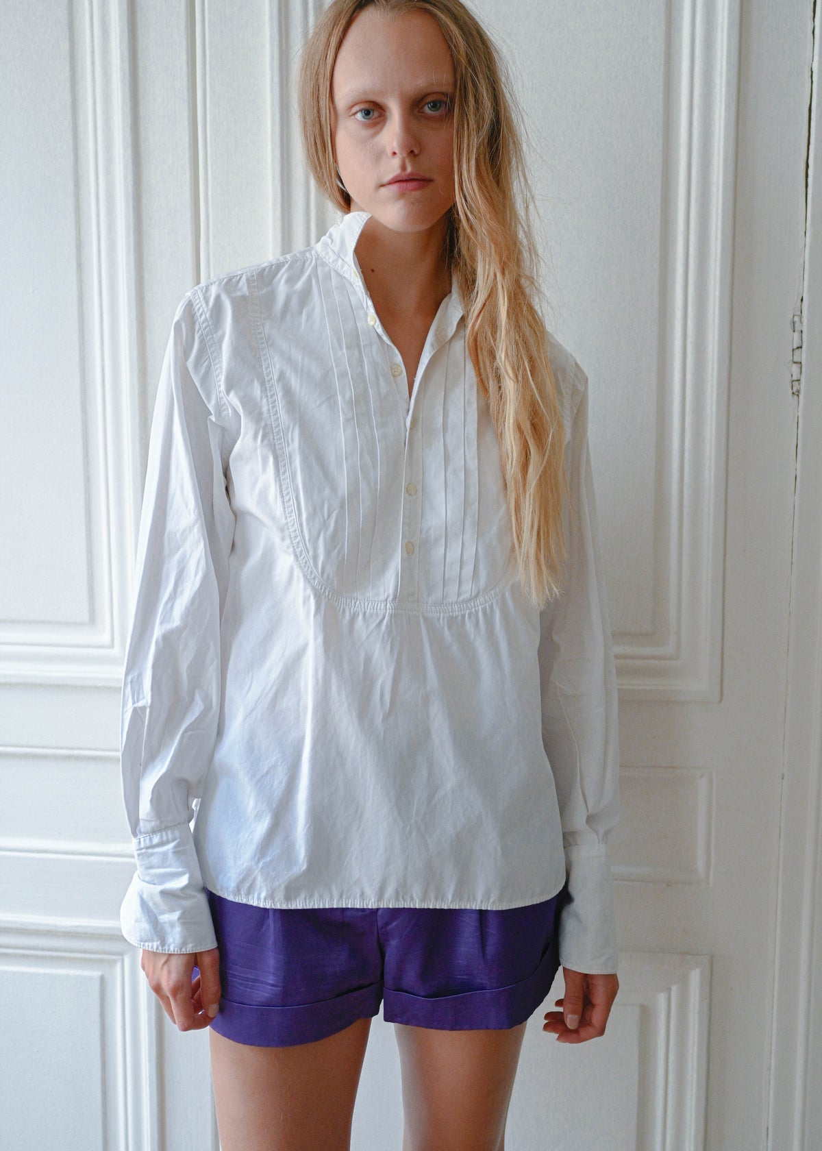 White cotton shirt worn with purple shorts, front view