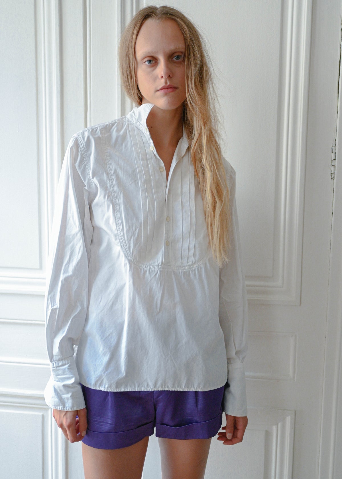 White cotton shirt worn with purple shorts, front view