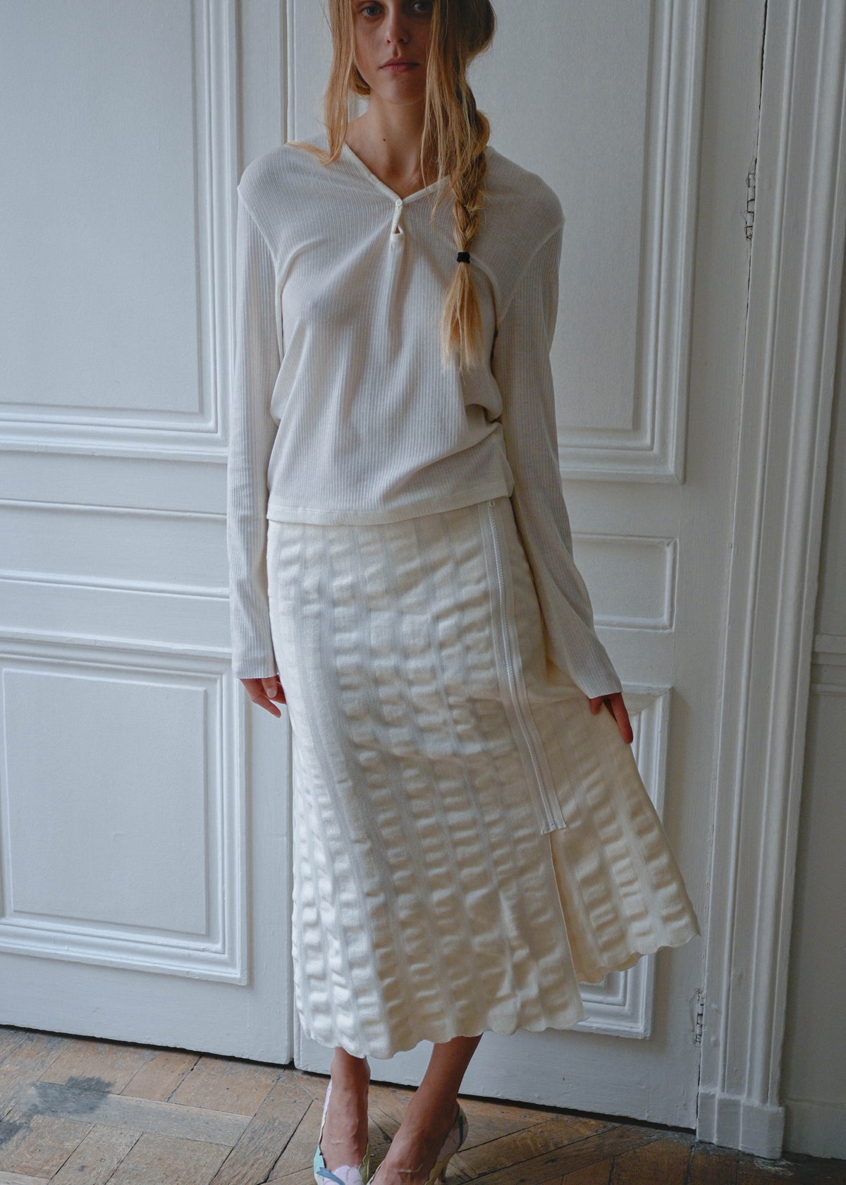 Cream knit maxi skirt worn with a white long sleeve top, front view