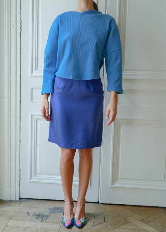Blue silk skirt worn with a blue top, front view