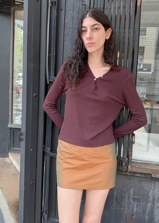 TURN Paris Tunisien-style top in brown with long sleeves, pearl buttoning and a cinched, structured silhouette.