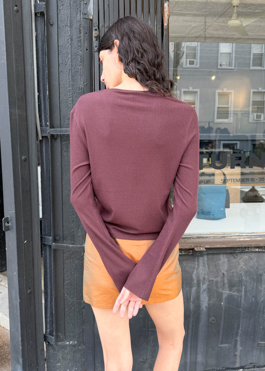 TURN Paris Tunisien-style top in brown with long sleeves, pearl buttoning and a cinched, structured silhouette.