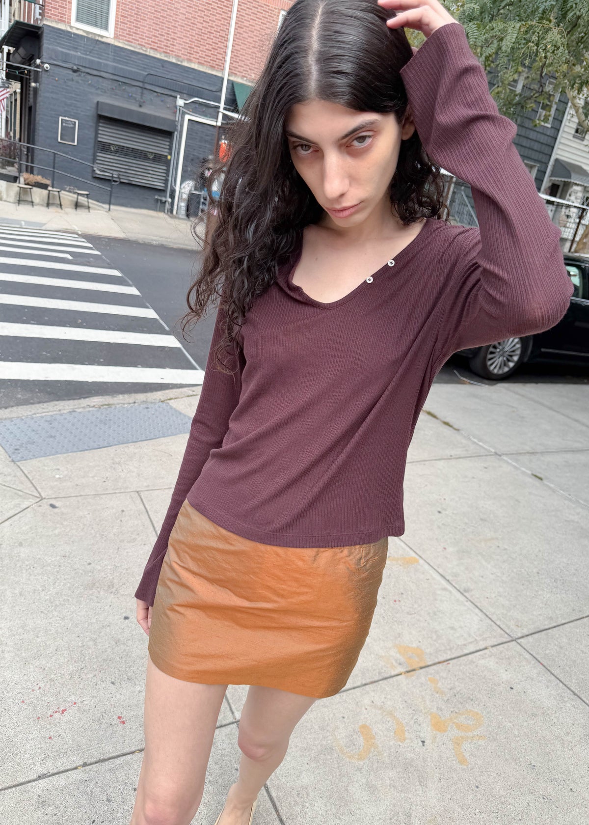 TURN Paris Tunisien-style top in brown with long sleeves, pearl buttoning and a cinched, structured silhouette.