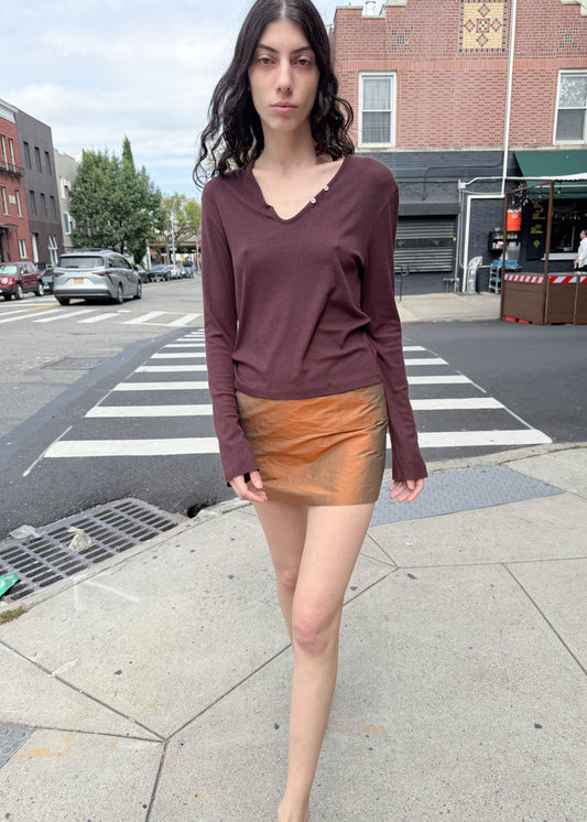 TURN Paris Tunisien-style top in brown with long sleeves, pearl buttoning and a cinched, structured silhouette.