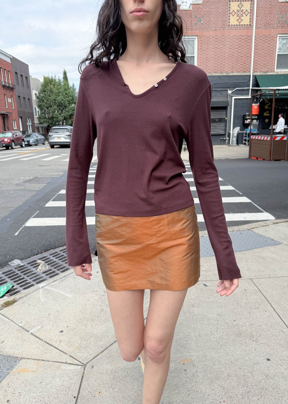 TURN Paris Tunisien-style top in brown with long sleeves, pearl buttoning and a cinched, structured silhouette.