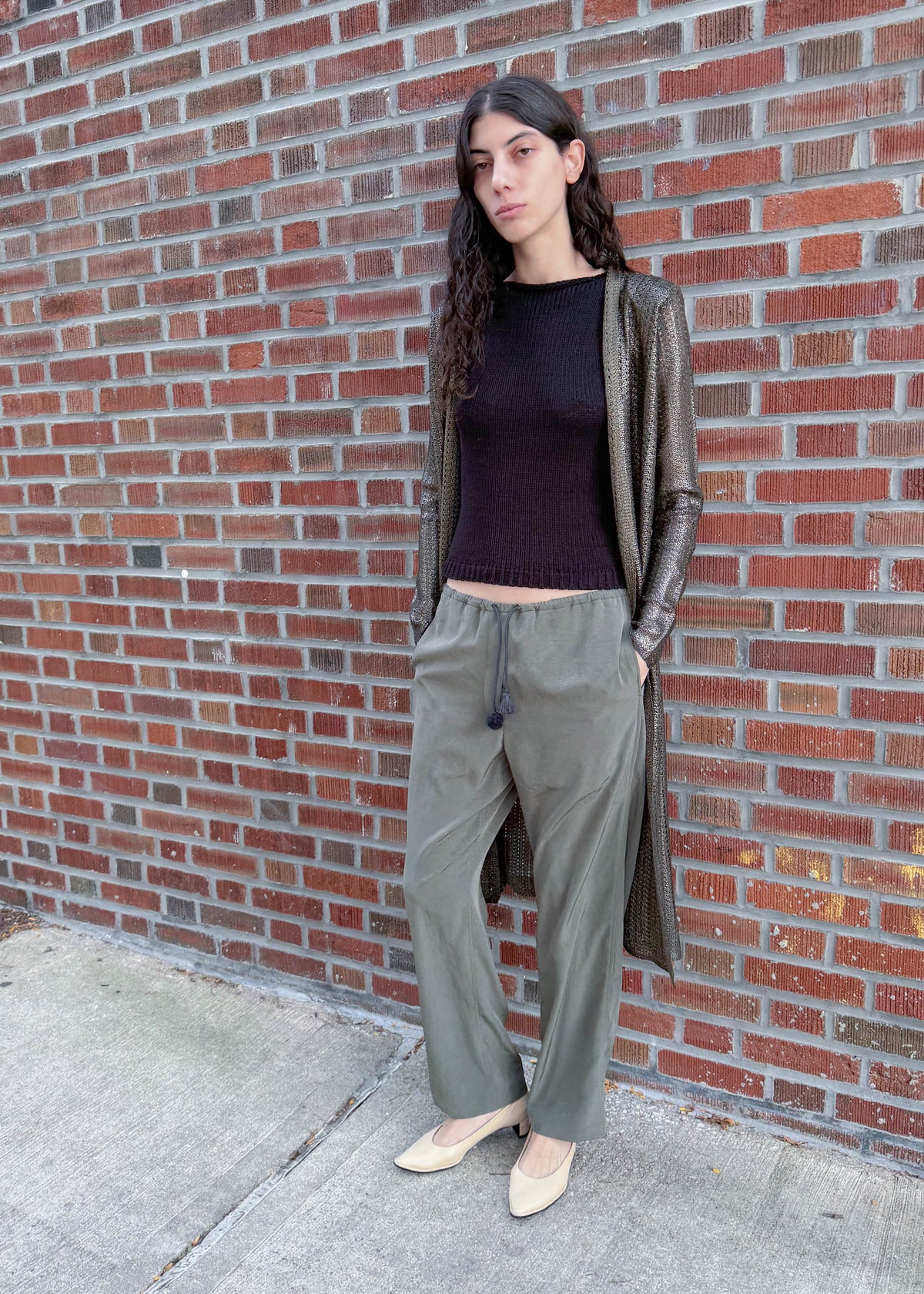 TURN Paris flowy loose pant in green, tied at the waist with a custom-made asymmetrical pompon made in France.