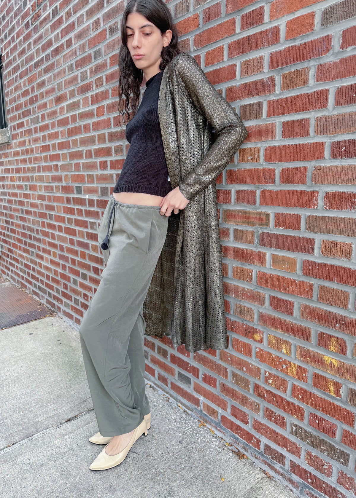 TURN Paris flowy loose pant in green, tied at the waist with a custom-made asymmetrical pompon made in France.