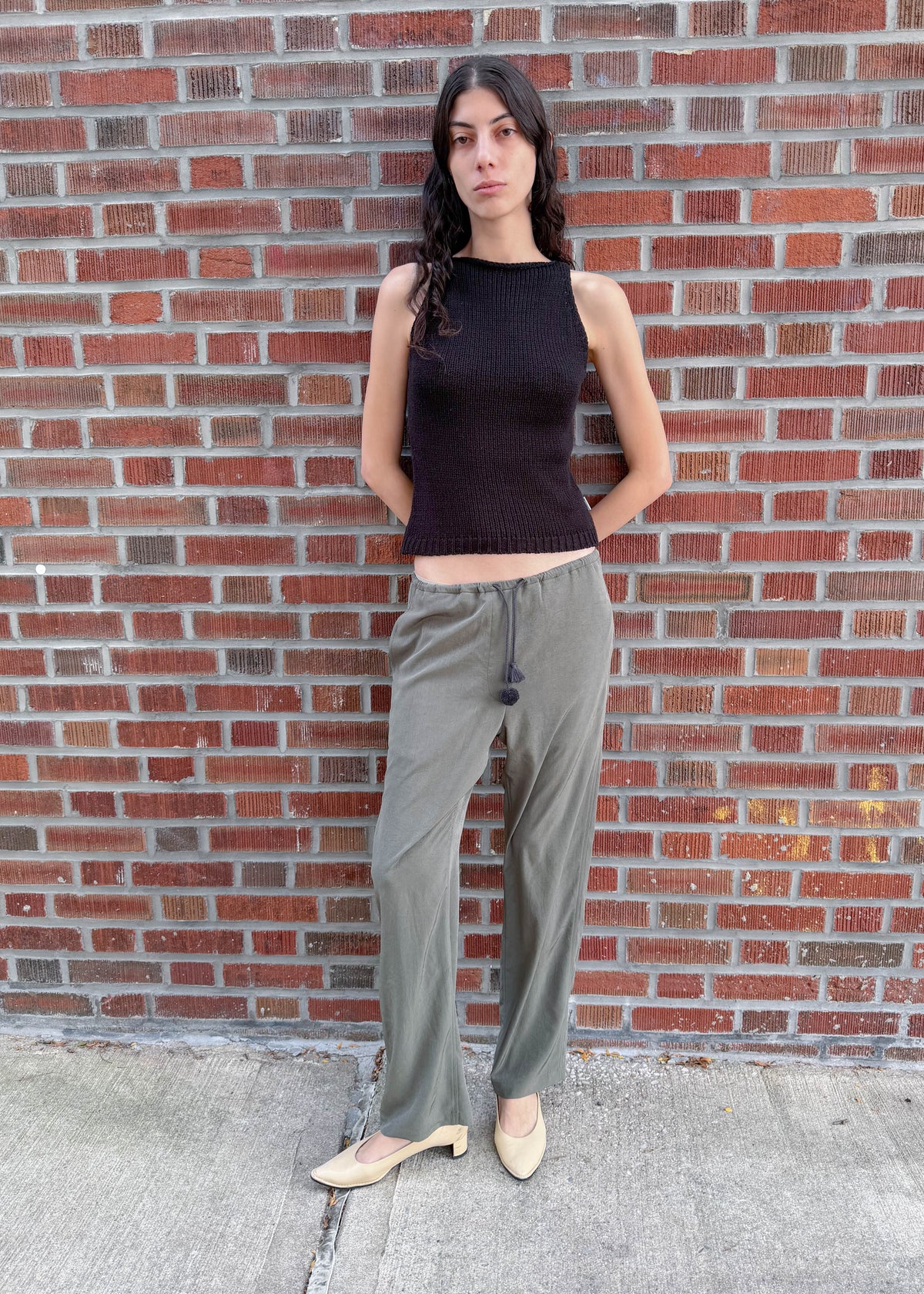 TURN Paris flowy loose pant in green, tied at the waist with a custom-made asymmetrical pompon made in France.