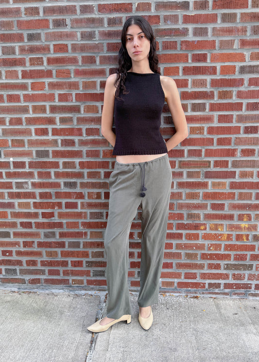 TURN Paris flowy loose pant in green, tied at the waist with a custom-made asymmetrical pompon made in France.