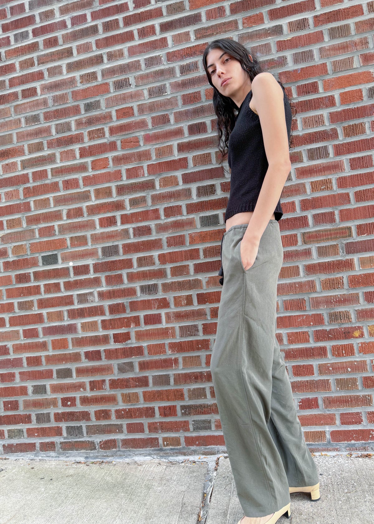 TURN Paris flowy loose pant in green, tied at the waist with a custom-made asymmetrical pompon made in France.