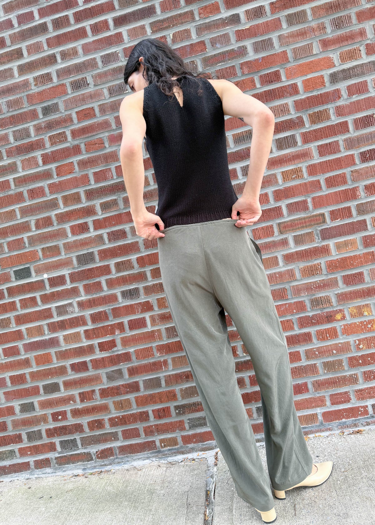 TURN Paris flowy loose pant in green, tied at the waist with a custom-made asymmetrical pompon made in France.