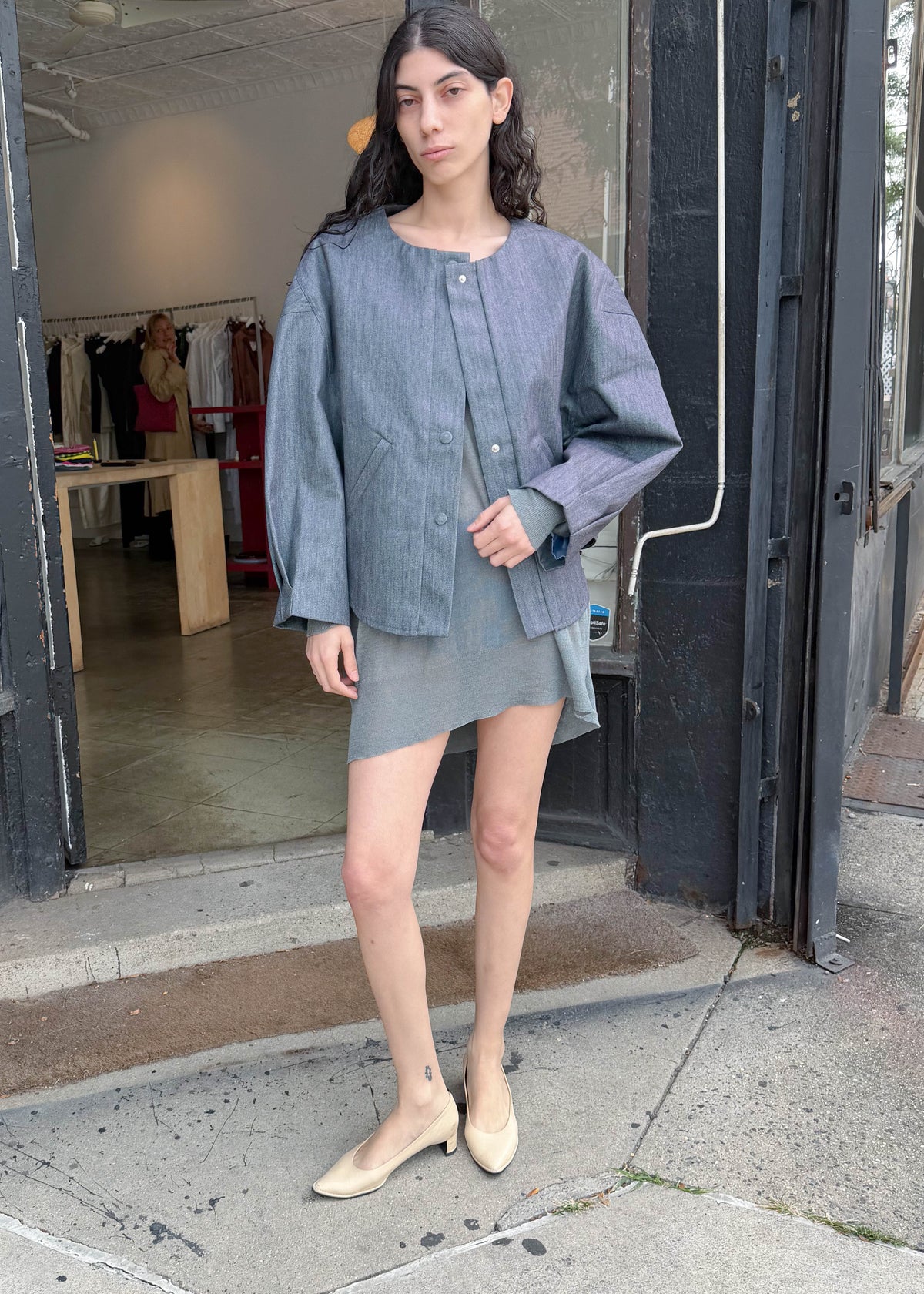 TURN Paris bomber jacket in glazed Japanese denim, cut in a boxy silhouette with rounded sleeves and slanted pockets, designed to enhance posture and subtly reveal the lower back.