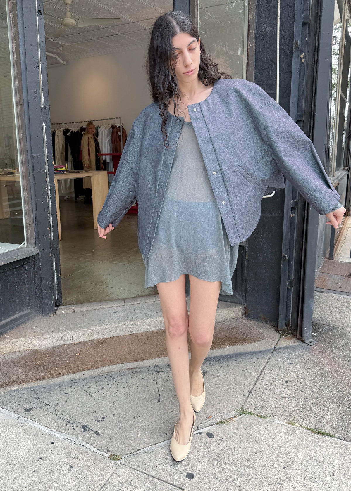 TURN Paris bomber jacket in glazed Japanese denim, cut in a boxy silhouette with rounded sleeves and slanted pockets, designed to enhance posture and subtly reveal the lower back.