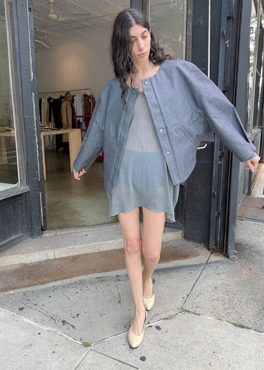TURN Paris bomber jacket in glazed Japanese denim, cut in a boxy silhouette with rounded sleeves and slanted pockets, designed to enhance posture and subtly reveal the lower back.