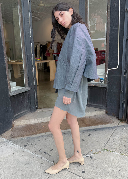 TURN Paris bomber jacket in glazed Japanese denim, cut in a boxy silhouette with rounded sleeves and slanted pockets, designed to enhance posture and subtly reveal the lower back.