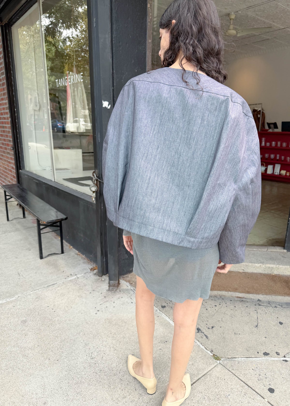 TURN Paris bomber jacket in glazed Japanese denim, cut in a boxy silhouette with rounded sleeves and slanted pockets, designed to enhance posture and subtly reveal the lower back.