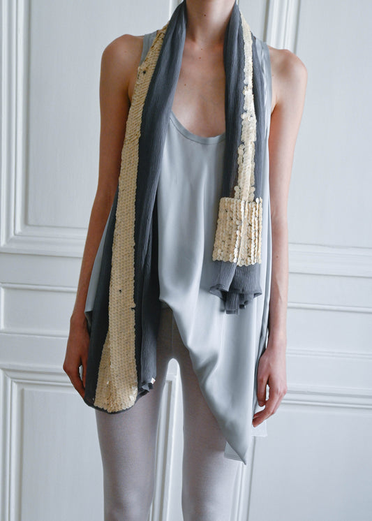 Grey T Scarf by TURN Paris worn long around the neck, silk crepe with beige sequin T